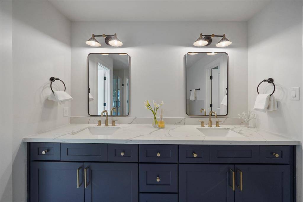 Dual sinnks with quartz countertops and cabinetry for storage.