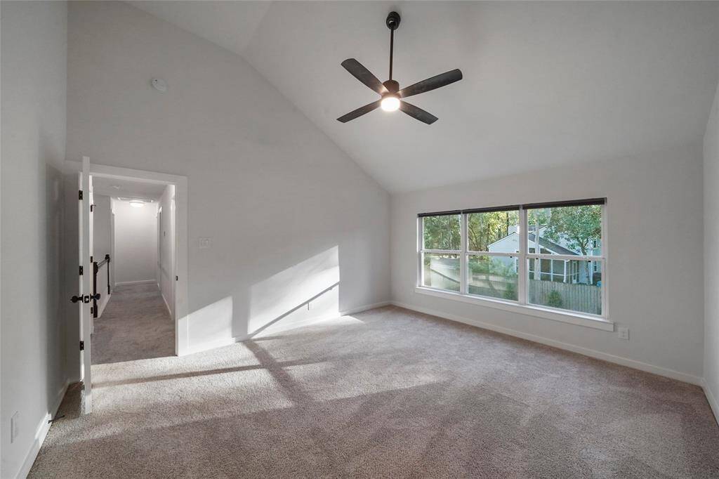 Primary bedroom is positioned at the other end of the hallway away from the secondary bedrooms.