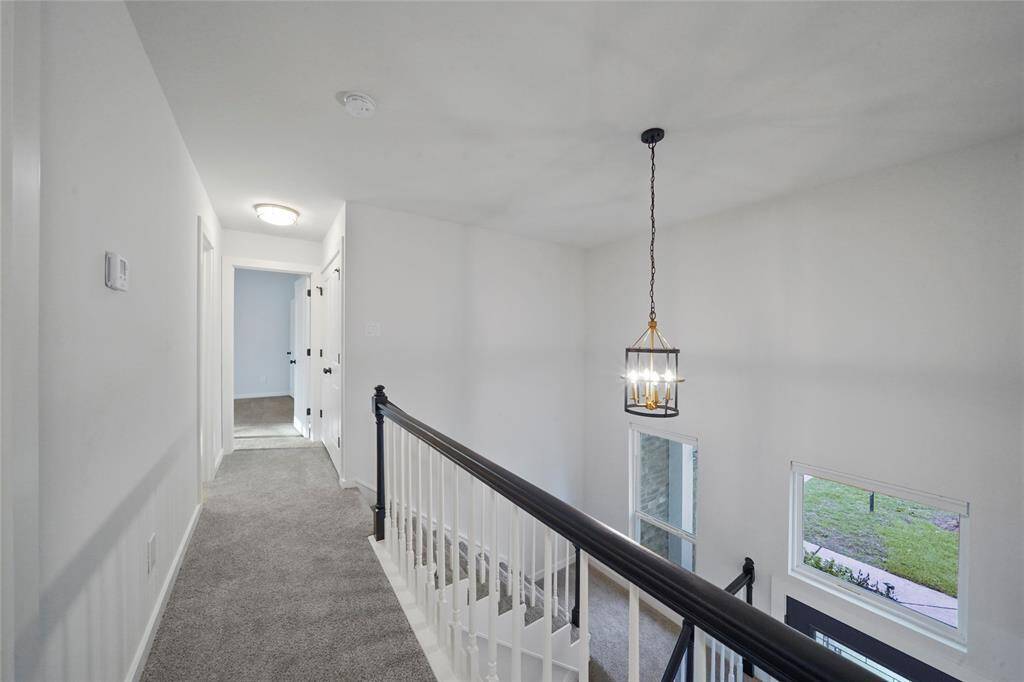 Upstairs laundry closet is just outside the primary bedroom and across from the secondary bathroom.