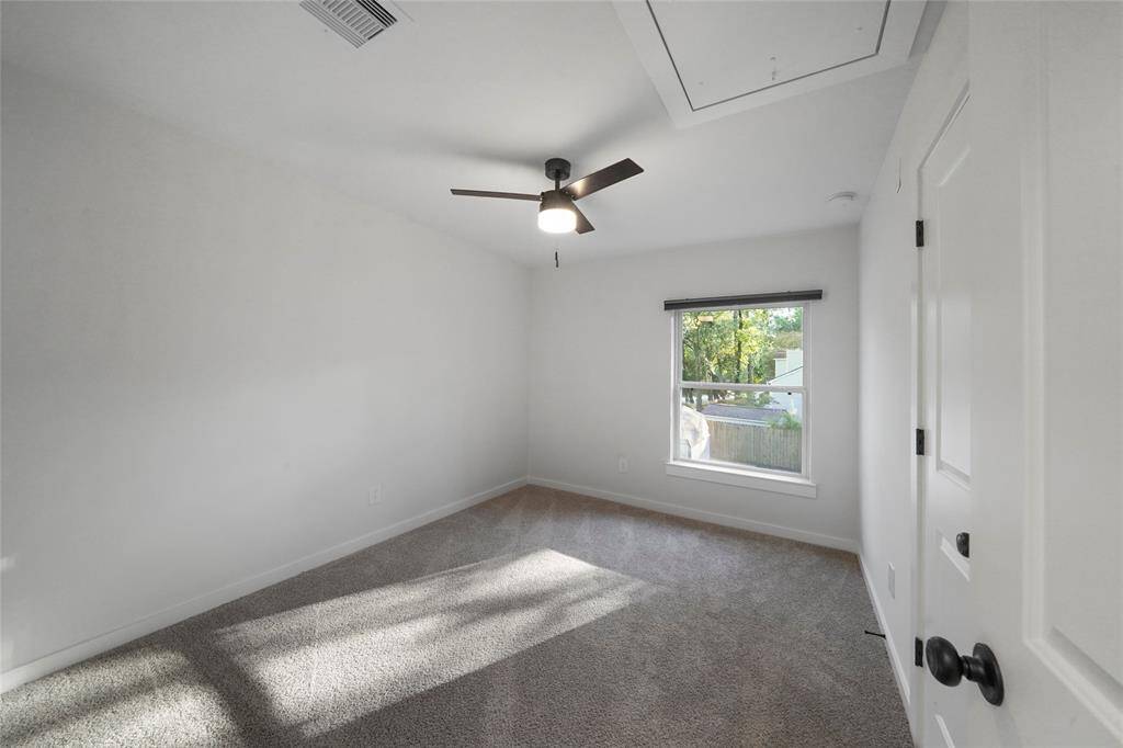 Bedroom #3 with fan and walk in closet.