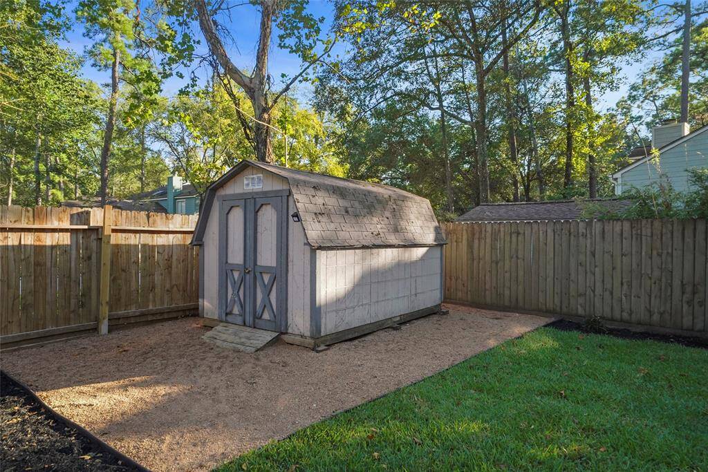 Storage shed provided for backyard games or gear.