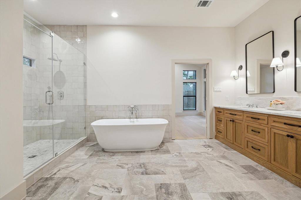 primary bath, free standing tub, hand crafted square tile shower, chrome & matte black finish.