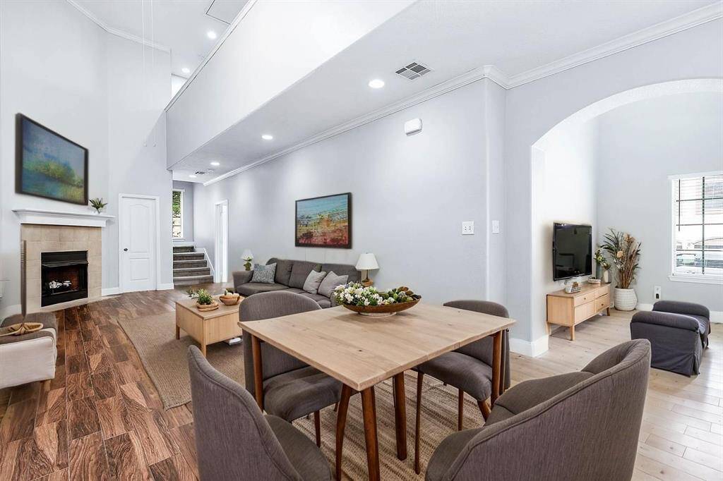 ** Virtually Staged - Living room boasting high ceiling and fireplace