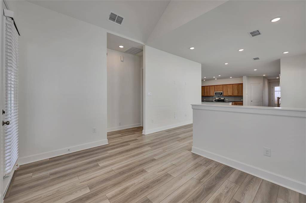 Another view of this Living Room that also featuresrecessed lighting and easyaccess to the Kitchen.