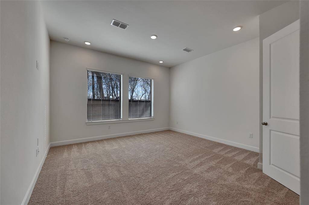 Pristine Primary Suiteaccompanied with plush carpet and notable amounts of naturallighting.