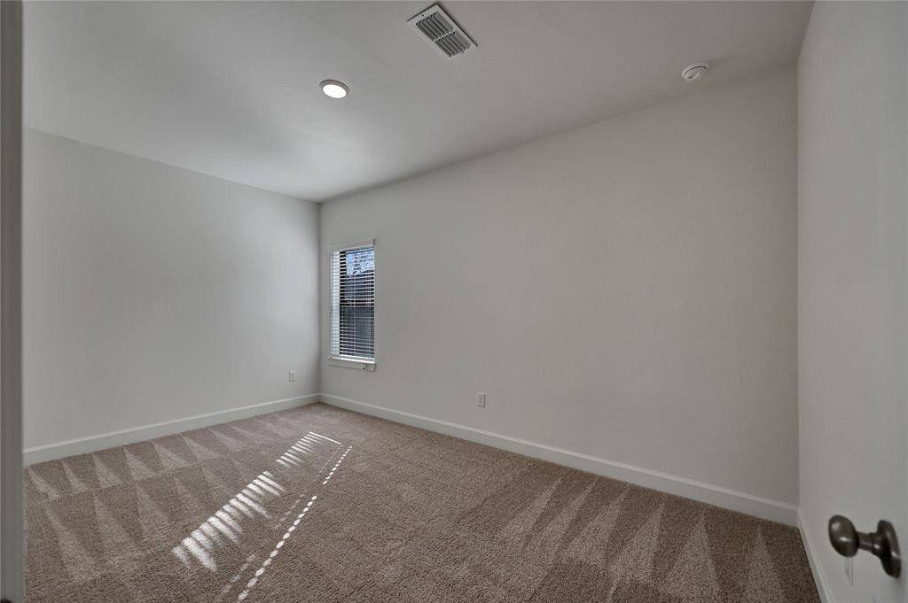 Spacious third Bedroomthat offers recessed lighting,ceiling fan, and natural lighting from the window.