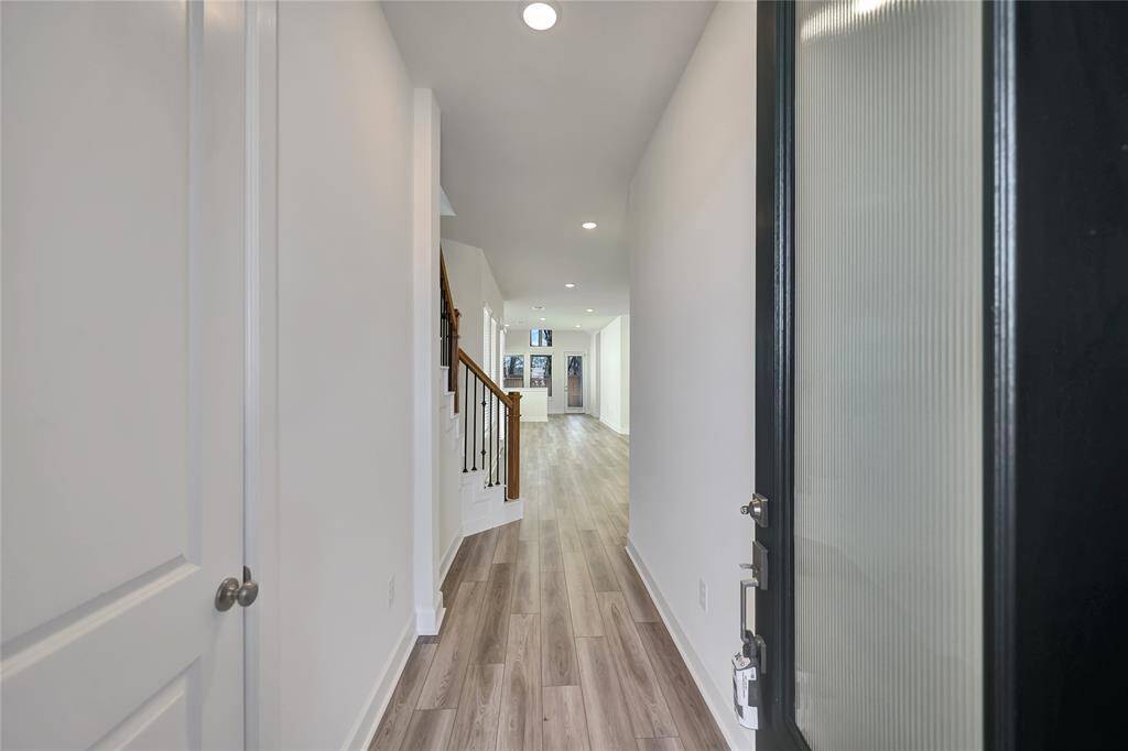 Entrywayaccompanied with wonderfulnice flooring and recessed lighting.