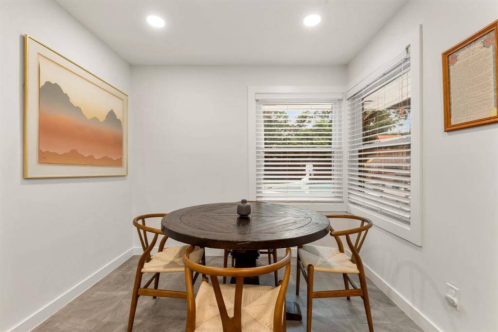 Lovely breakfast area with window overlooking the backyard oasis