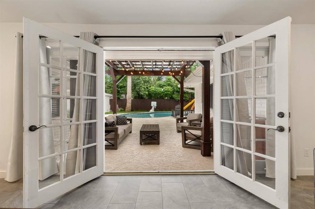 Open the dual french doors during the spring or fall months and enjoy your view of this incredible backyard oasis