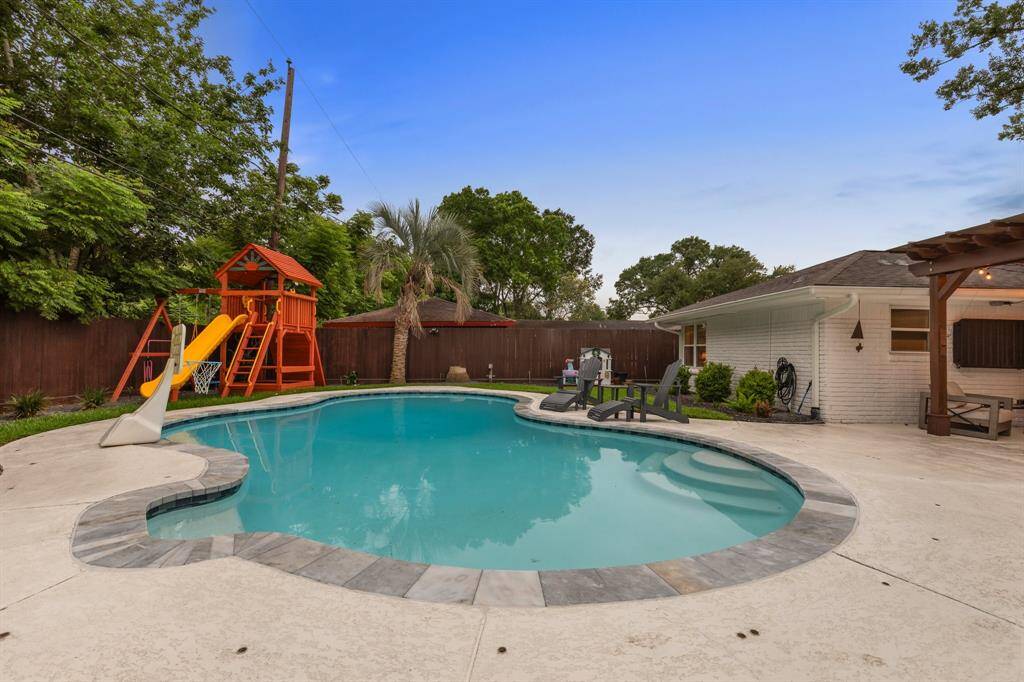 The backyard is full of mature trees, expansive play area, and plenty of decking area for chairs and relaxing.