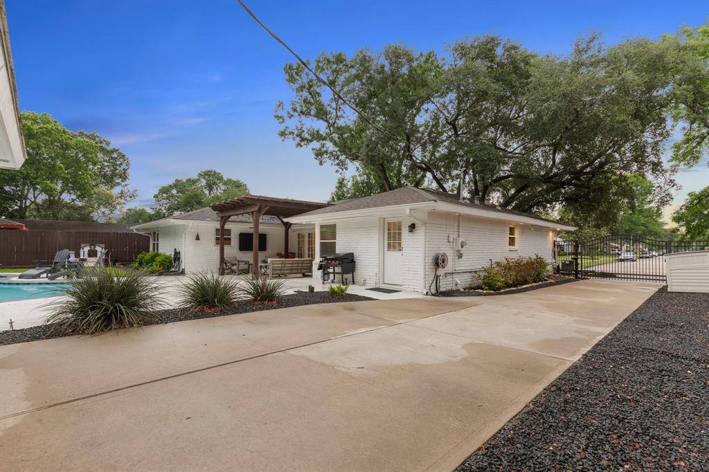 Expansive driveway that is designed to accommodate two large SUVs side-by-side ensures ample parking for family and guests alike.