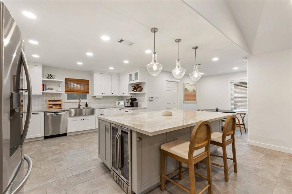 The heart of this home is its completely reimagined kitchen showcasing quartzite counters, professional-grade Z-Line 6 burner gas stove and range for the aspiring chef, LG refrigerator, built-in Sharp drawer microwave, ultra-quiet Bosch dishwasher, Ferguson lighting, and modern PEX plumbing system for reliability and peace of mind.