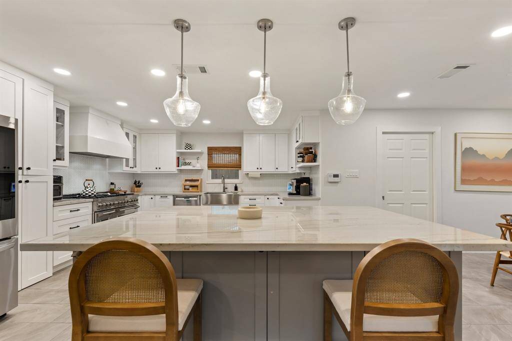 Gather around the expansive island for family gatherings, casual weeknight dinners, or breakfast before work or school. With the island, breakfast room, and large formal dining area, there is more than enough space to host your friends and family.