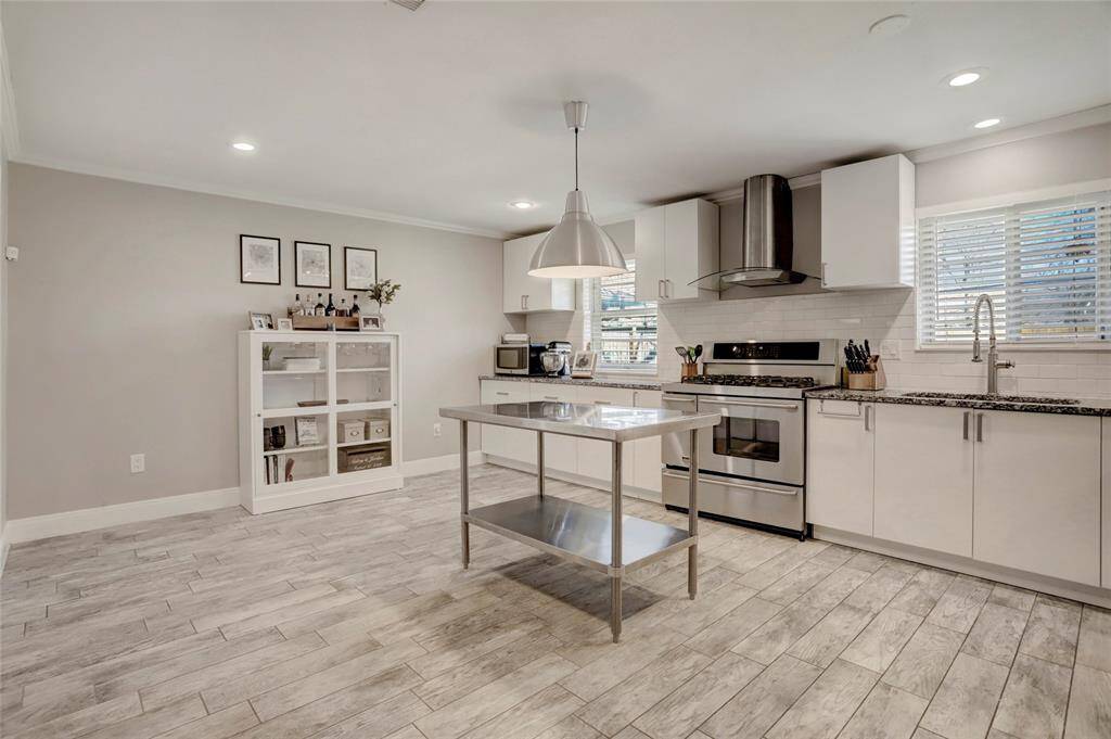 Light and bright with lots of windows. Recessed lights and ceiling fans. Soothing Neutral colors throughout. Hallway leads to bedrooms.