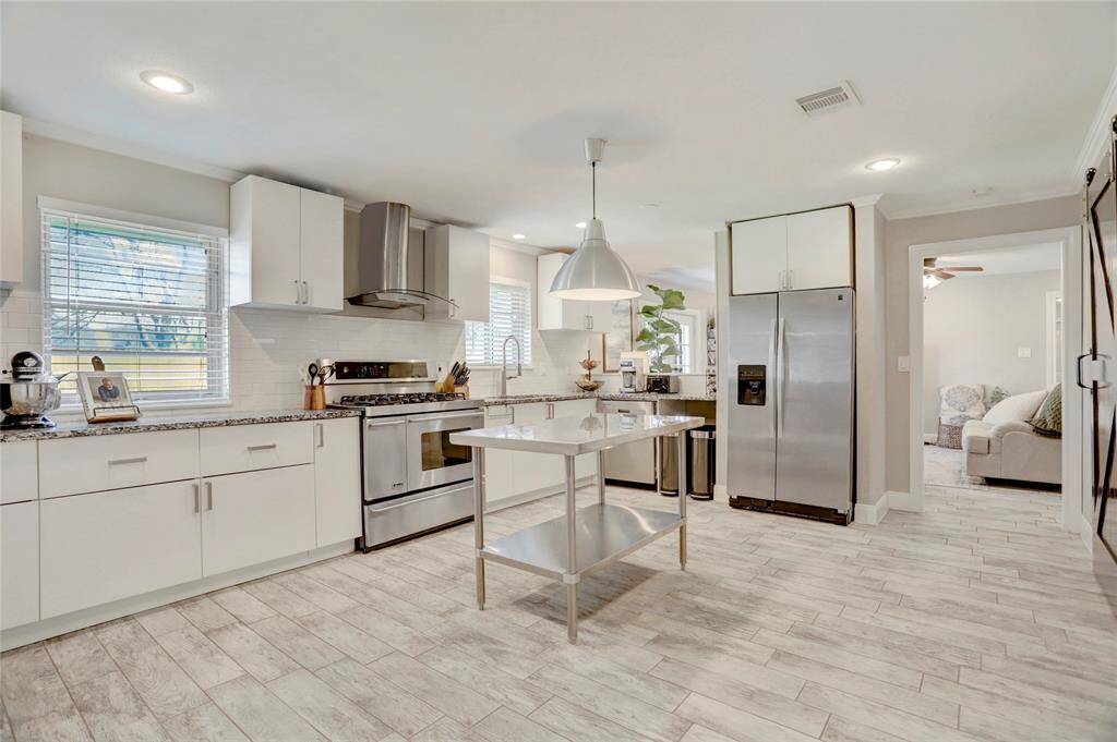 Another view of this stunning kitchen with lots of counterspace!