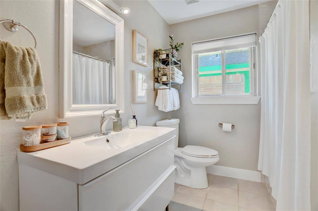 Guest bathroom with tub. Storage in vanity. There is also additional linen storage cabinets behind the bathroom door.  Exhaust fans in both bathrooms. Dual flush toilets in both bathrooms.