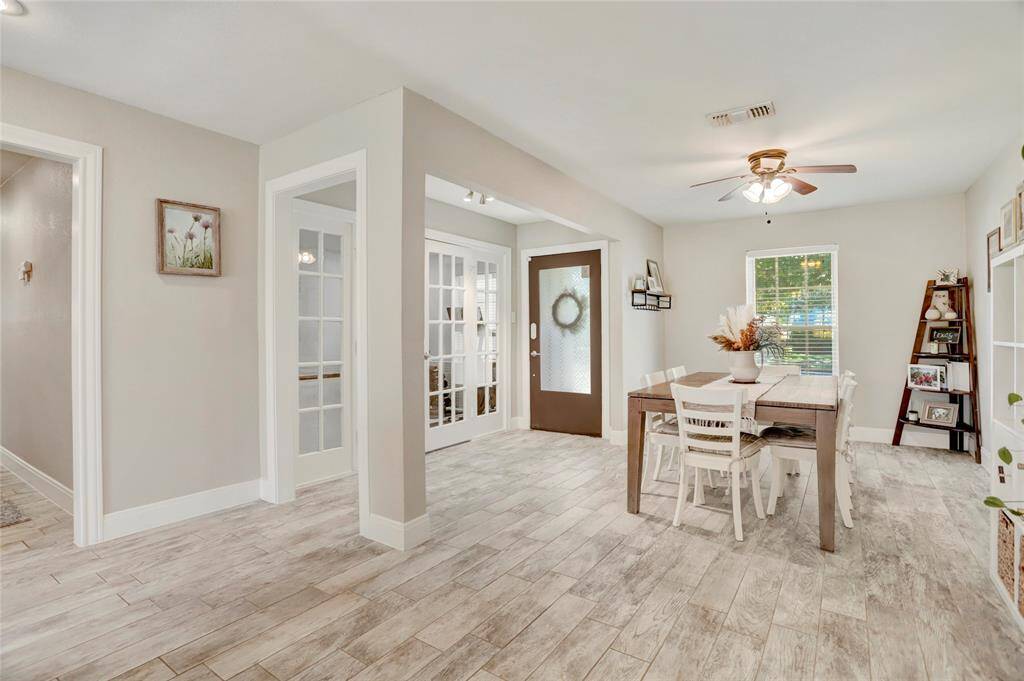 View from front entry looking toward the living area. Notice the wood grain patterned tile floors.