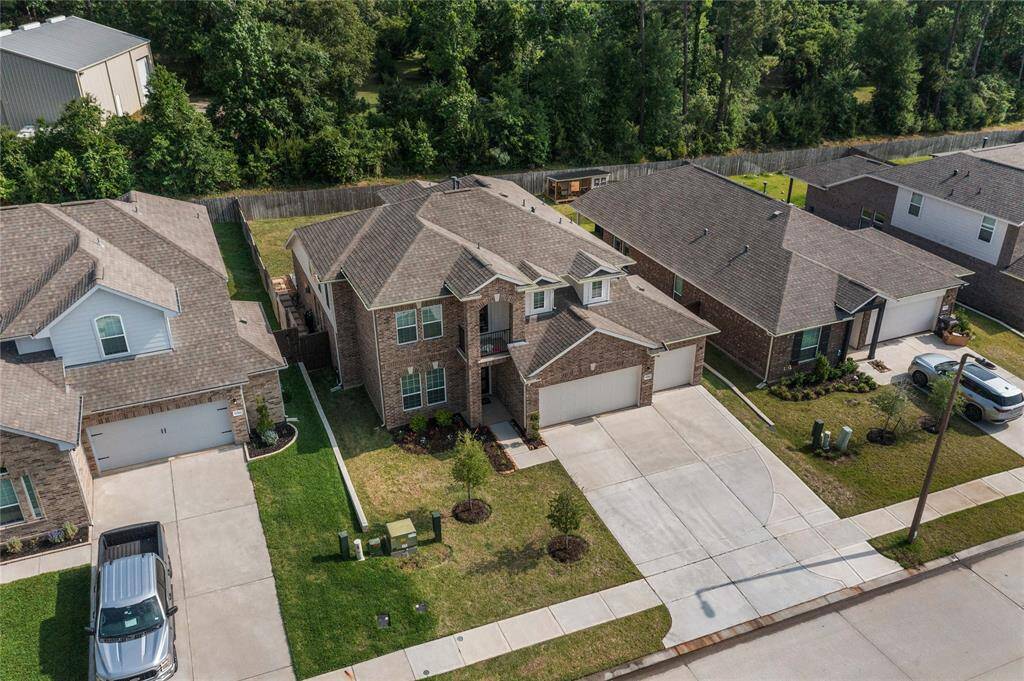 Notice the 3 car wide driveway
