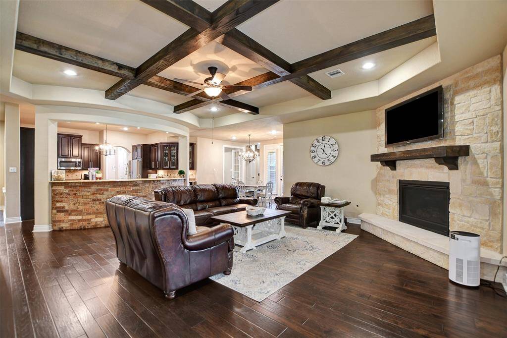 Beautiful fireplace and custom crossbeam ceiling.