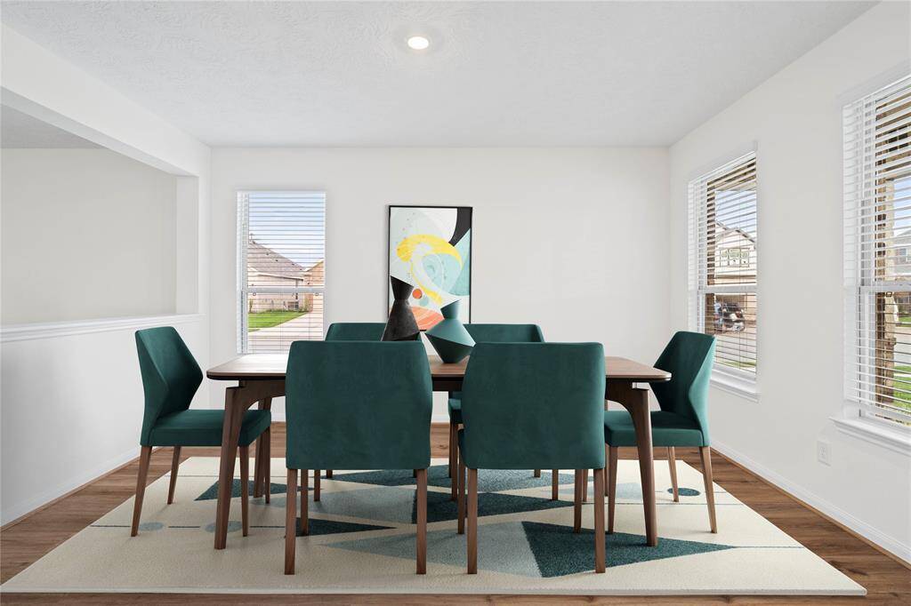 Make memories gathered around the table with your family and friends! This flex space located at the front of the home here is featured as a dining room. The room features high ceilings, recessed lighting, large windows with privacy blinds, vinyl plank flooring, and neutral paint!