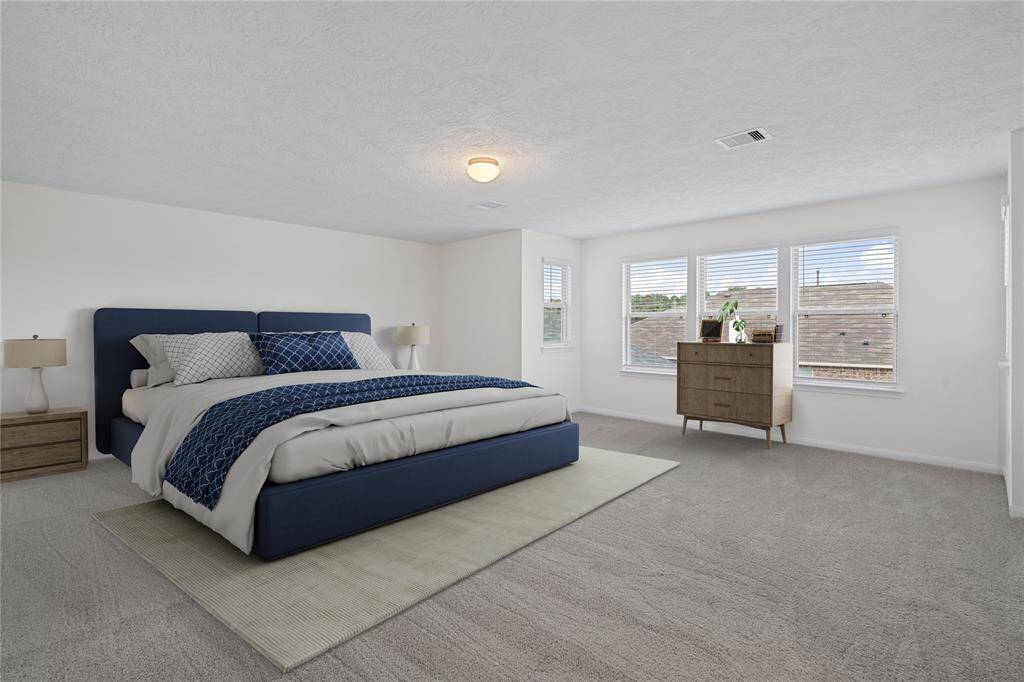 What a wonderful place to come home to, this stunning primary suite greets you with gorgeous plush carpet, custom paint, high ceiling, lighting, lovely windows with blinds allowing in natural light brightening up this spacious primary bedroom!