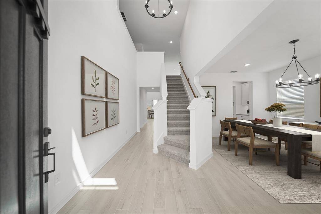 Inviting entrance with sweeping staircase