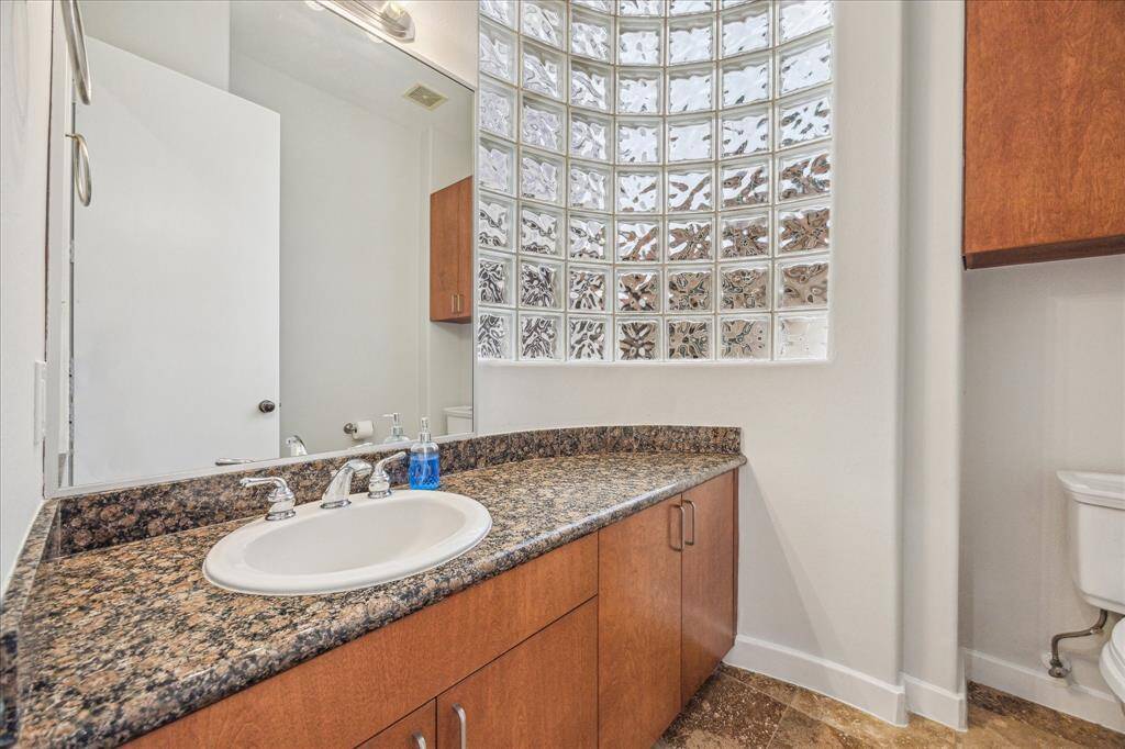 Glass blocks in the powder room off the living room. Granite counter top and plenty of storage.