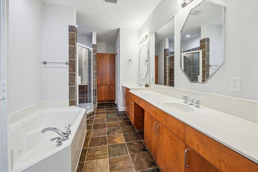 Double sinks and richly appointed fixtures and hardware in the primary bath and secondary bathrooms.