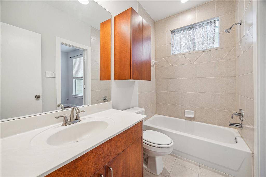Secondary en-suite bathroom with tub/shower combo and plenty of storage.