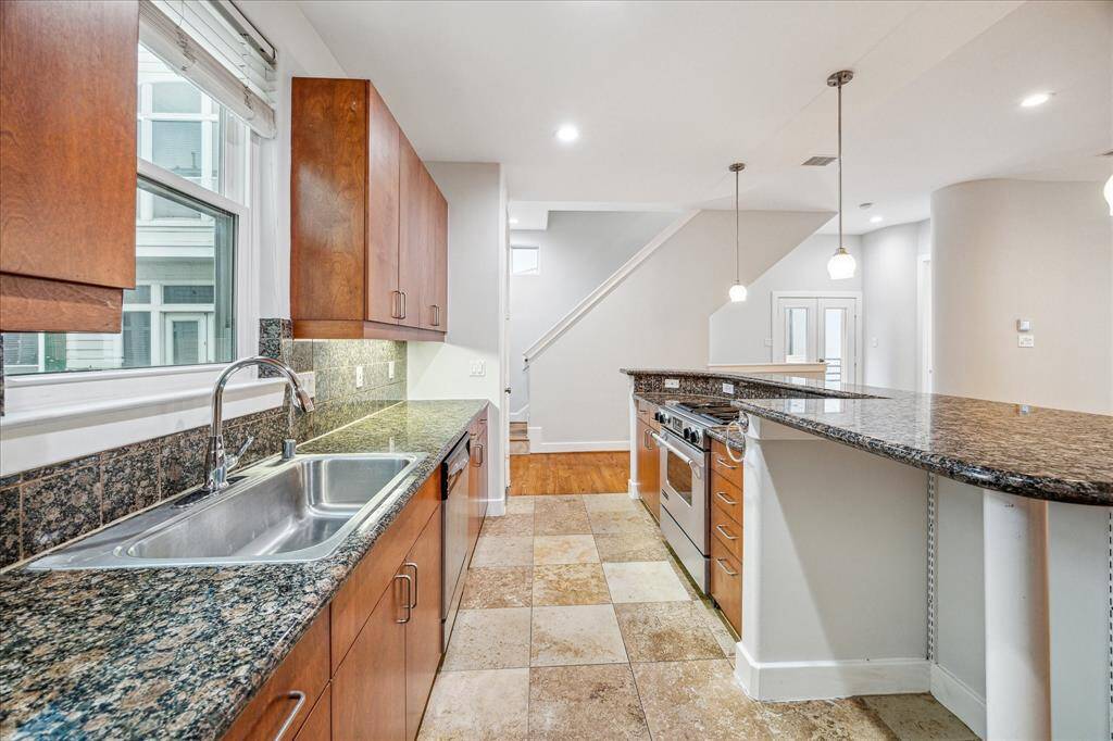 Cooks dream kitchen with granite counter tops and travertine flooring.