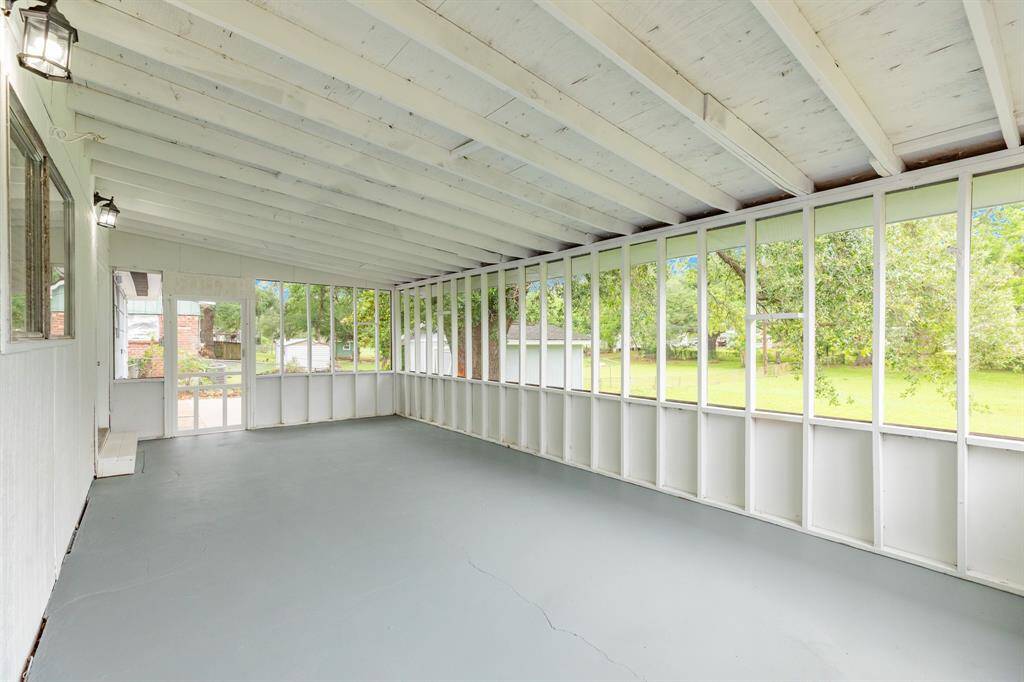 Oversized covered and screened in patio. Perfect for enjoying the serene backyard views.
