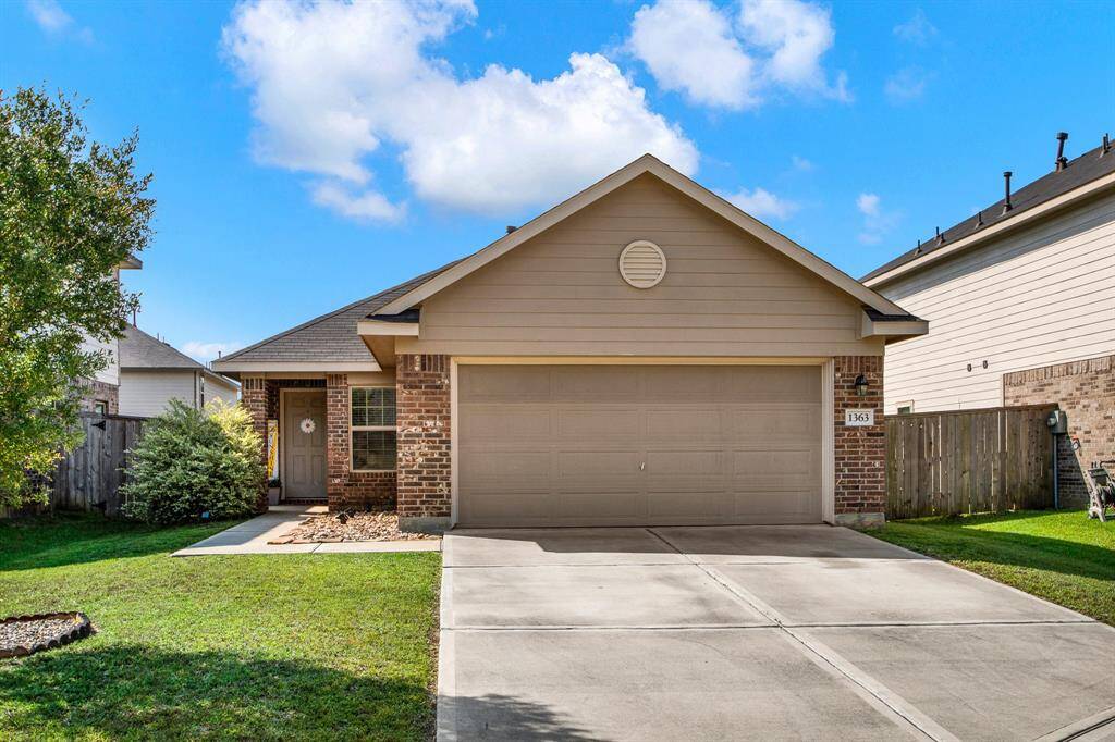 Charming single-story home with a brick facade and attached two-car garage. The front yard is well-maintained with a sidewalk and shrubs leading to the front door. Ideal for comfortable living in a friendly neighborhood.