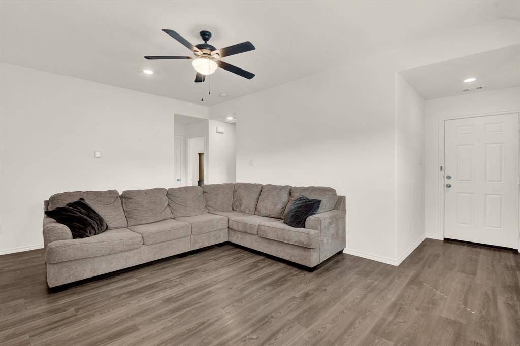 This charming single-story home features a brick and siding exterior with a two-car garage. It has a welcoming front entry and a well-maintained lawn, providing great curb appeal.