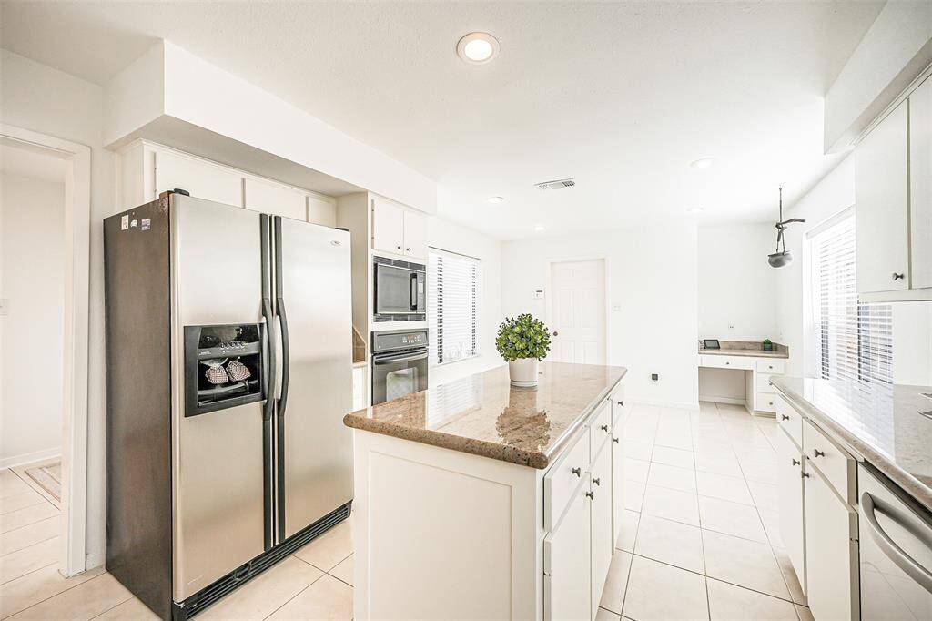 Gourmet Kitchen with terrific tile flooring, island for additional cooking space and views to Breakfast Area