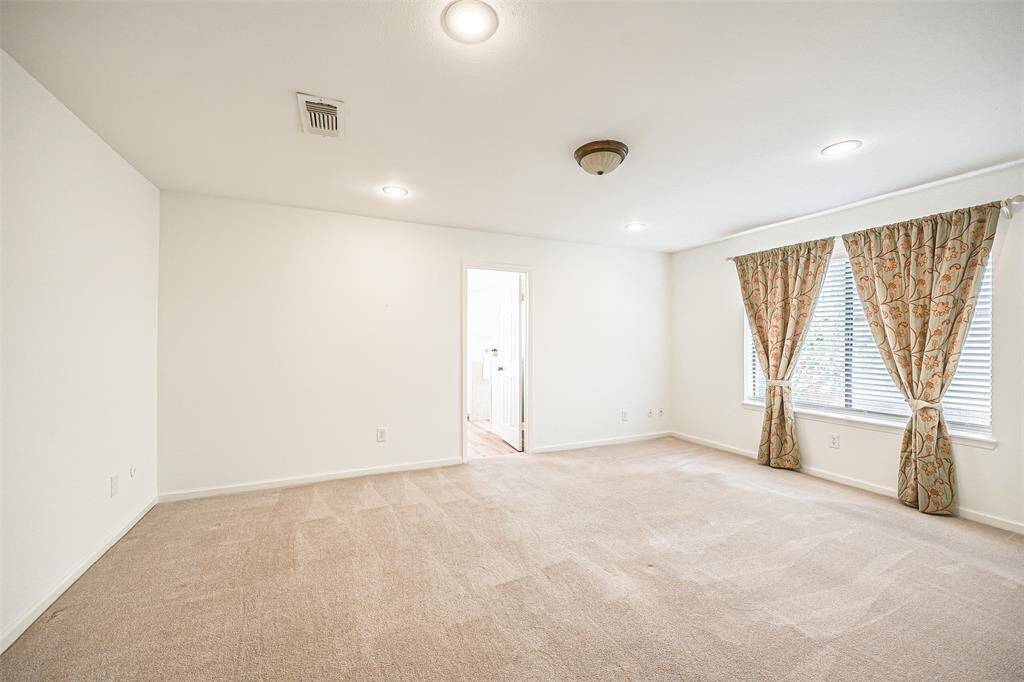 Primary Suite with plush carpet, wonderful windows adding natural lighitng and an abundance of space to retreat to after a long day