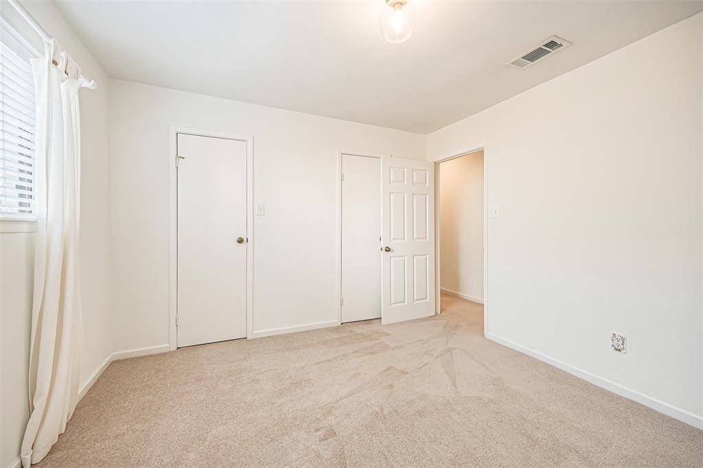 Secondary Bedroom with carpet, window with natural lighting and closet space