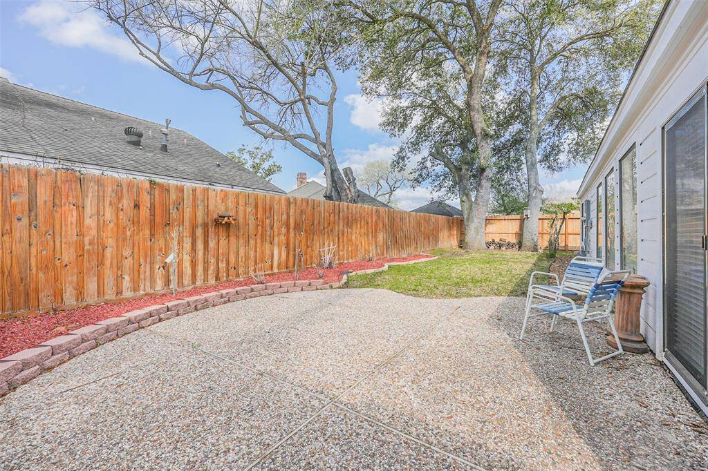 Beautiful Backyard with patio for time together outside, greenspace and mature trees for shading