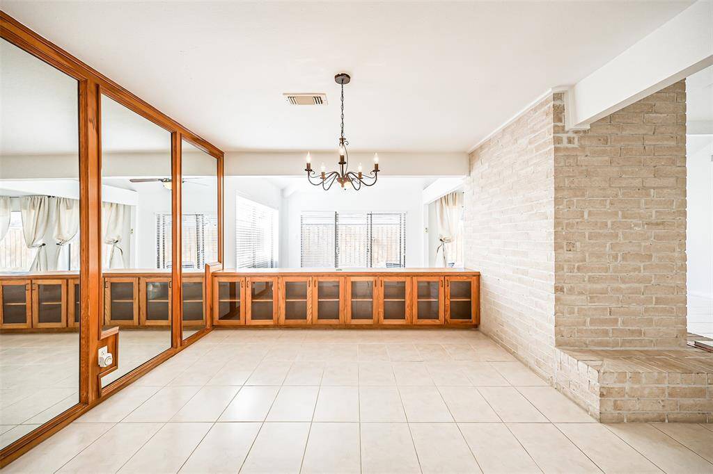 Dedicated Dining Room with tile floors, cabinetry and mirros to ensure entertaining is done in elegance each time.