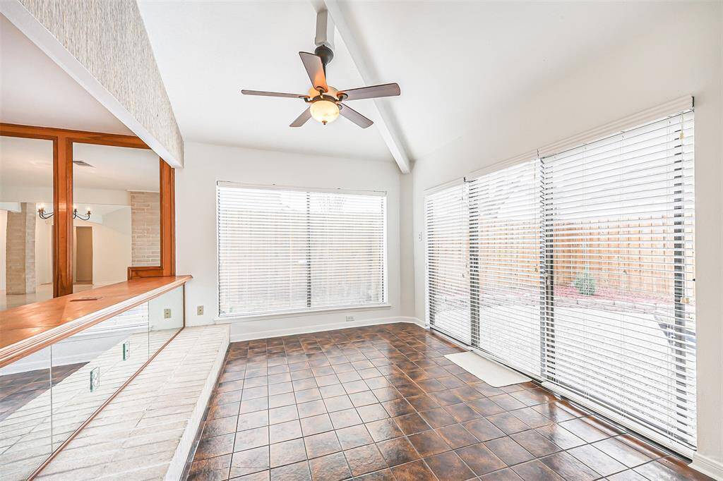 Wonderful area for time together with wall of windows, ceiling fan with lighting and backyard access.