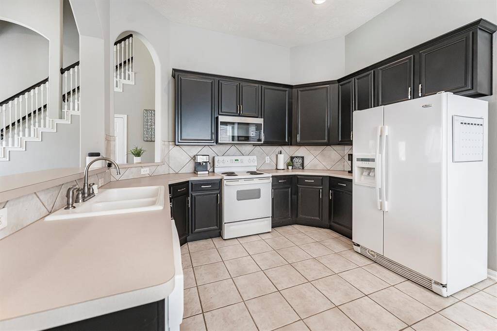 This roomy kitchen has all the space you need, ample counters, tons of cabinets, and a big pantry to stash every gadget you love. Time to cook up something fun!