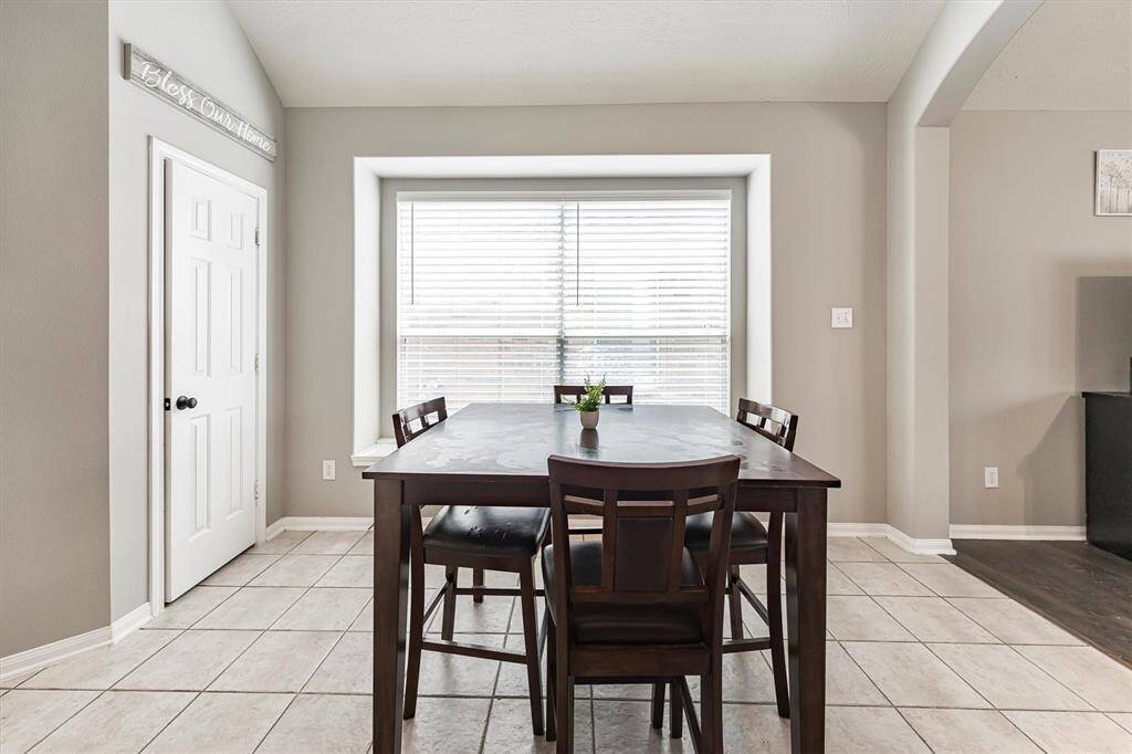 This spacious breakfast area has plenty of room for a large breakfast table with an oversized window with a window ledge.