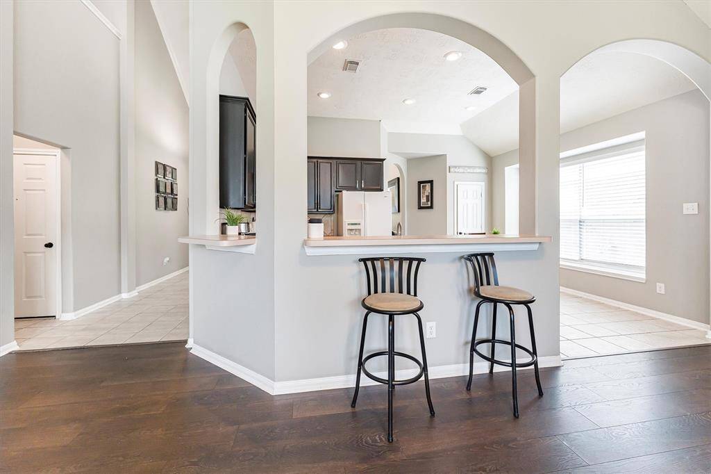 Pull up a seat! This handy bar between the kitchen and family room is perfect for quick bites, serving up snacks, or swapping stories with the family chef.