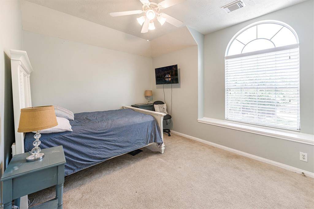 With two inviting guest bedrooms, you will always have room for company. This charming bedroom offers soft neutral finishes, a raised ceiling with a cooling fan, beautiful arched window that fills the room with natural light. It also offers a large closet and easy access to a full bathroom.