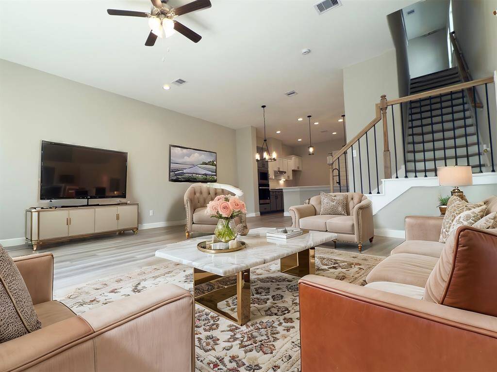 The ROCburne's living room was designed to be both elegant and versatile, allowing for various furniture layouts to suit the homeowner's lifestyle. *Image is virtually staged and depicts similar floorplan with same Fresh Pine flooring.