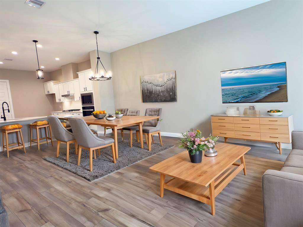 Discover an oasis of refined elegance in this stunning dining area, where every meal turns into a luxurious banquet. The ROCburne's multi-use room is a versatile space designed to adapt to various needs, whether as a home office, entertainment area, or media room. Image depicts similar product at another ROC Homes community and is virtually staged.