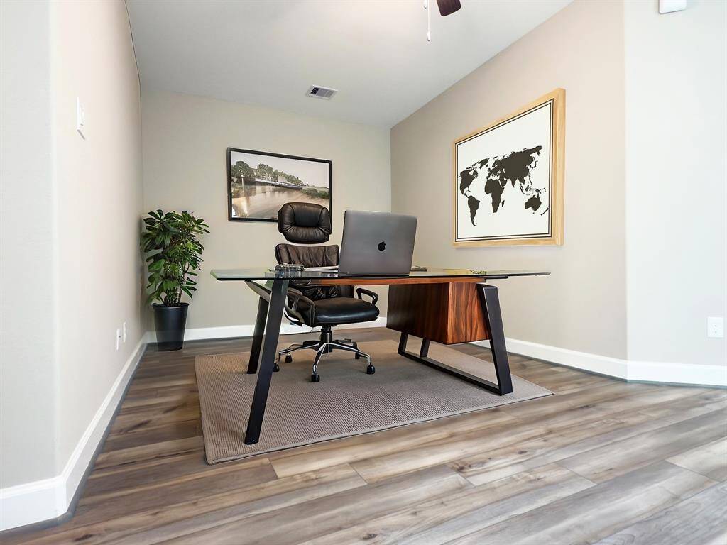The ROCburne's multi-use room is a versatile space designed to adapt to various needs, whether as a home office, entertainment area, or media room. Image depicts similar product at another ROC Homes community and is virtually staged.