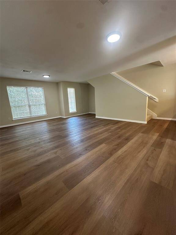 Photos are of a town home with the same floor plan. The town home for lease is a flipped version of this floor plan with a tile entry, vinyl floors in kitchen and bathrooms, carpet throughout, white range, white dishwasher, and the same stainless fridge as you see in these photos.