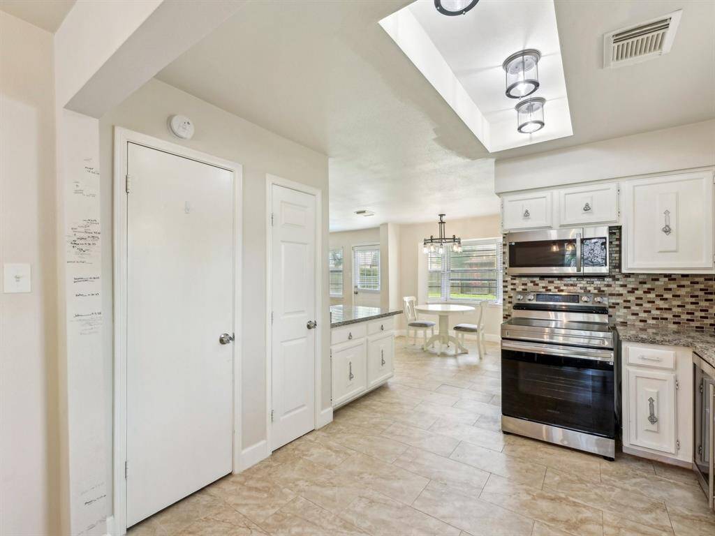 This home has a generous pantry and to the left of it is a storage closet that could hold your small appliances.