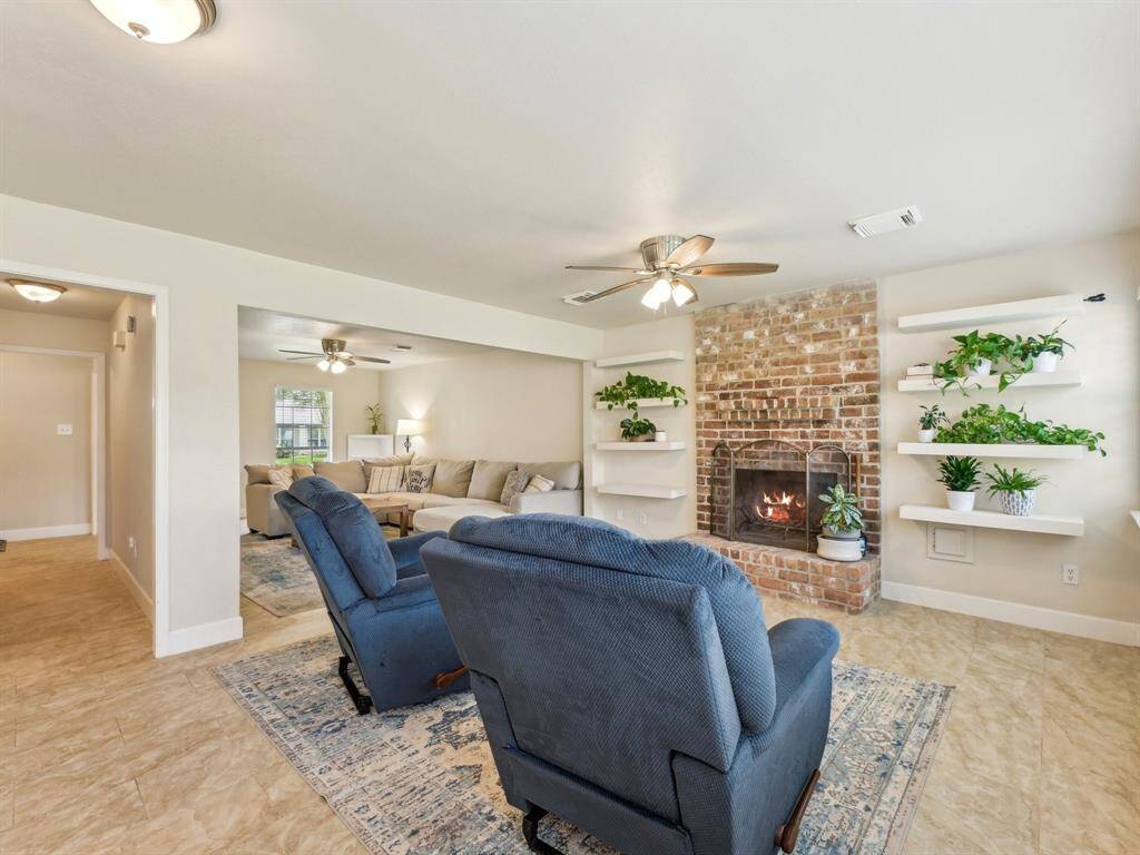 The Family Room has beautiful floating shelves and a gas log fireplace - perfect for warming a chilly night or setting the tone for a relaxing evening!