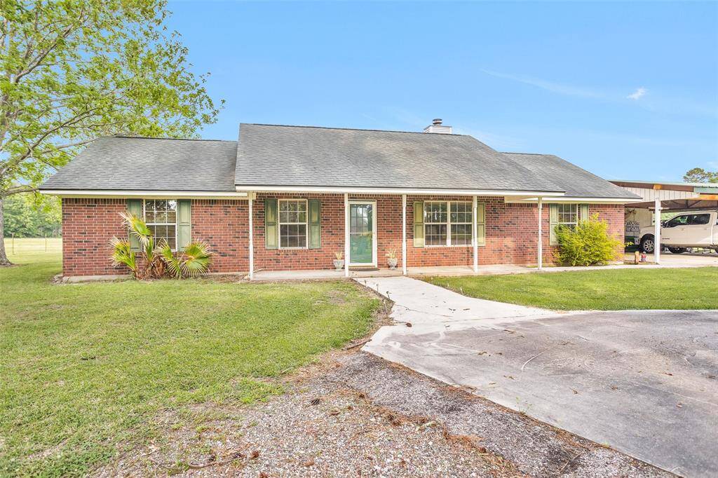 Front of home with detached carport and garage